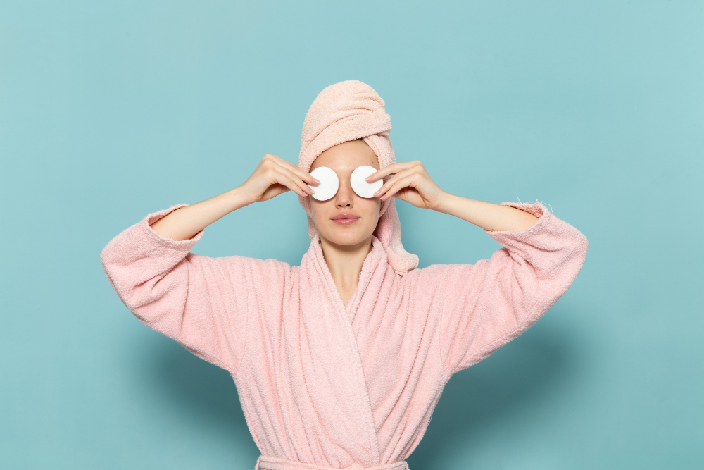 young-female-pink-bathrobe-after-shower-covering-her-eyes-blue
