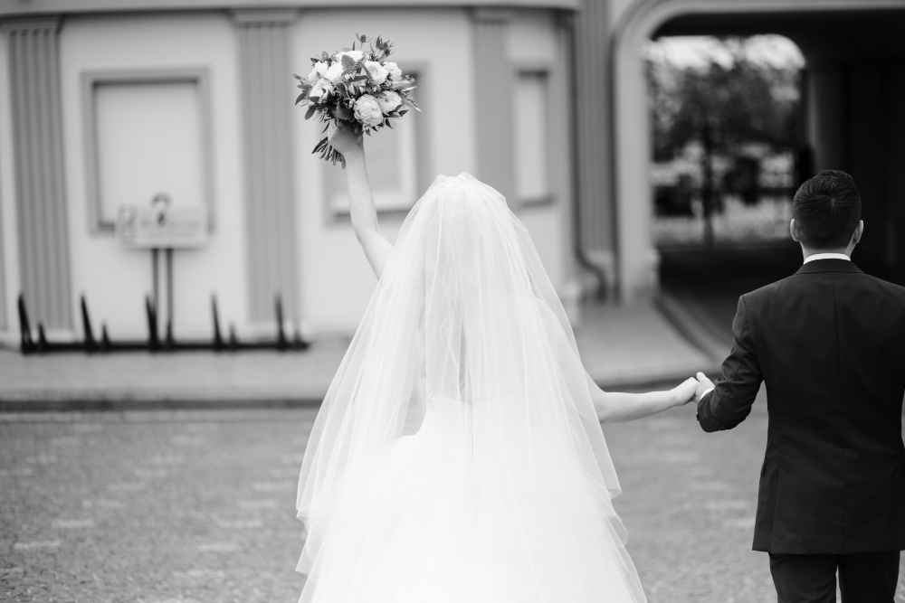 bride-groom-hold-their-hands-together-while-walking-around