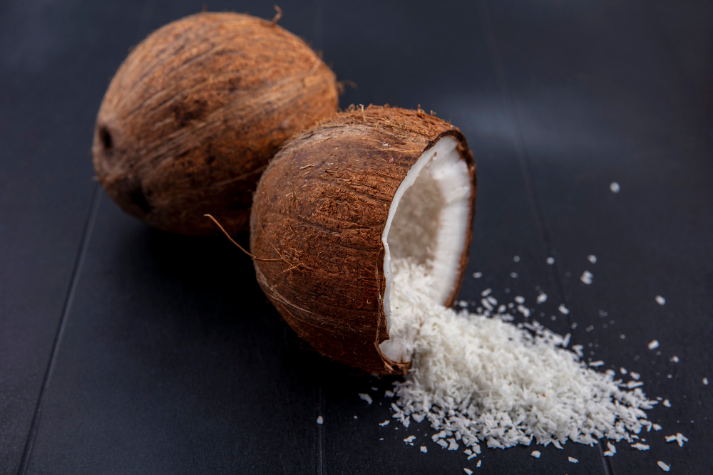 side-view-fresh-brown-coconuts-with-coconut-powder-black-surface