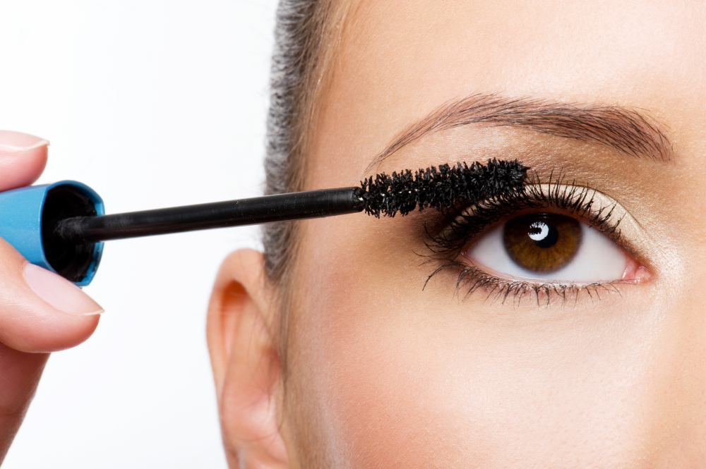woman-applying-mascara-her-eyelashes-macro-shot-1